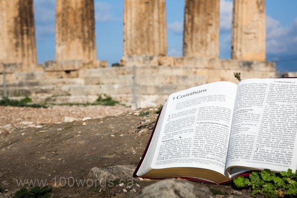 The Bible is opened to 1st Corinthians in front of the Temple of Apollo in ancient Corinth.