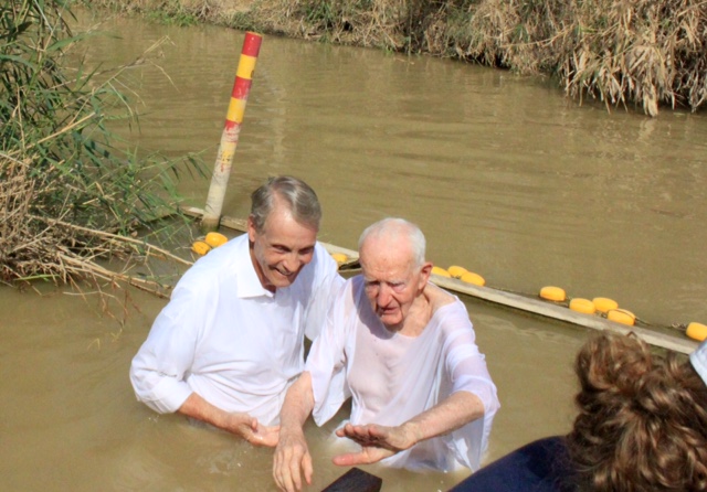 Just after baptizing 89-year-old Larry Burgess from Ottawa, Ontario, Canada.  We are on the Israel side of Jordan. The reeds you see are in the Kingdom of Jordan. So much river water is used for irrigation that the river is much smaller than in Bible times.